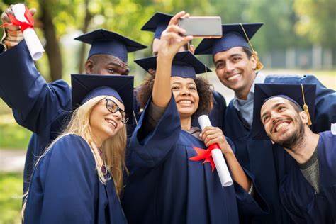 six people taking a picture whilst wearing their graduation cap and gown 